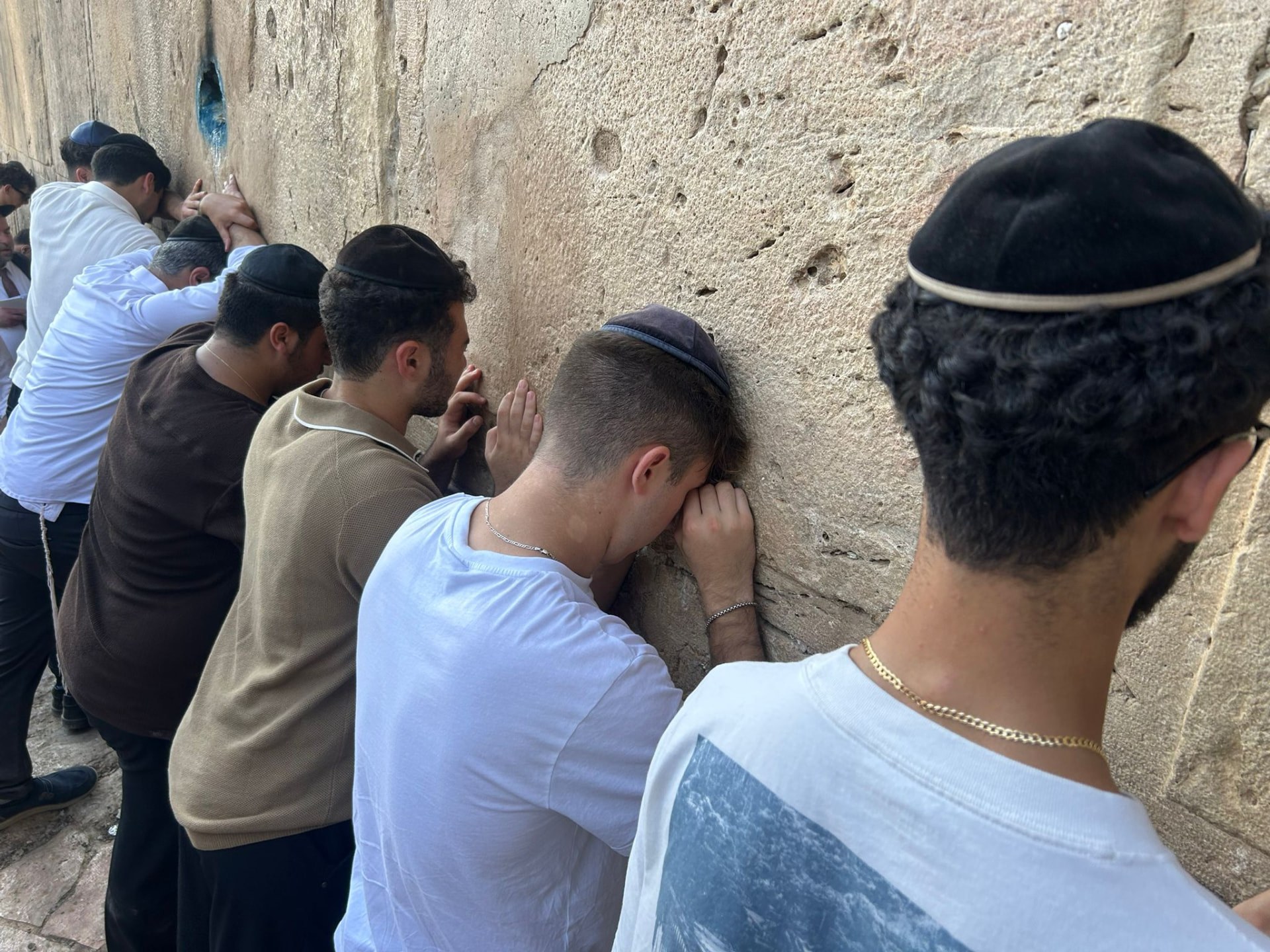 Talmidim davening at the Kotel