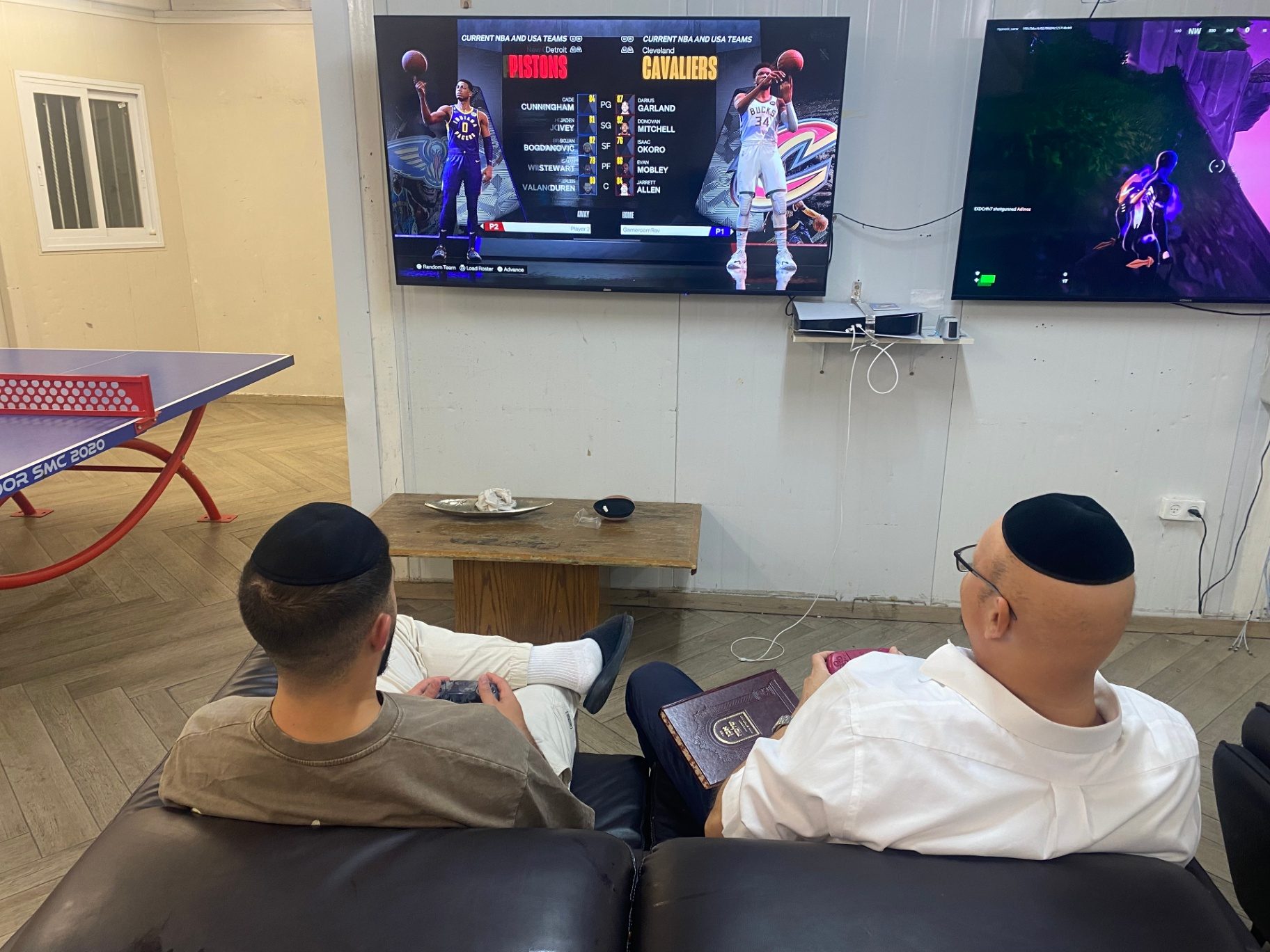 Talmidim relaxing on couches in the game room lounge
