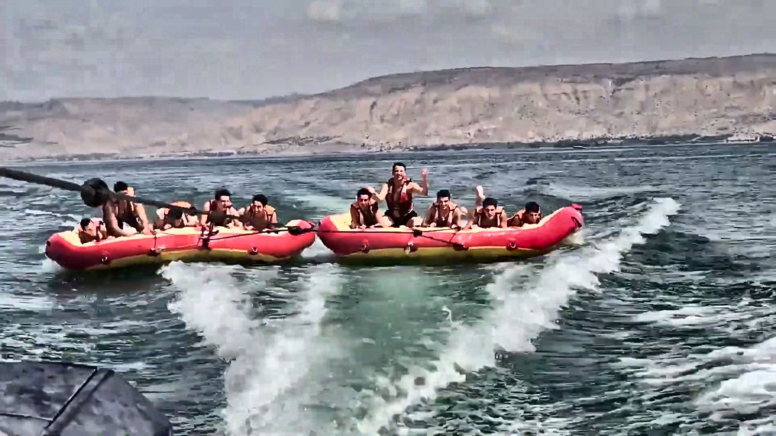 Talmidim riding a banana boat on the water