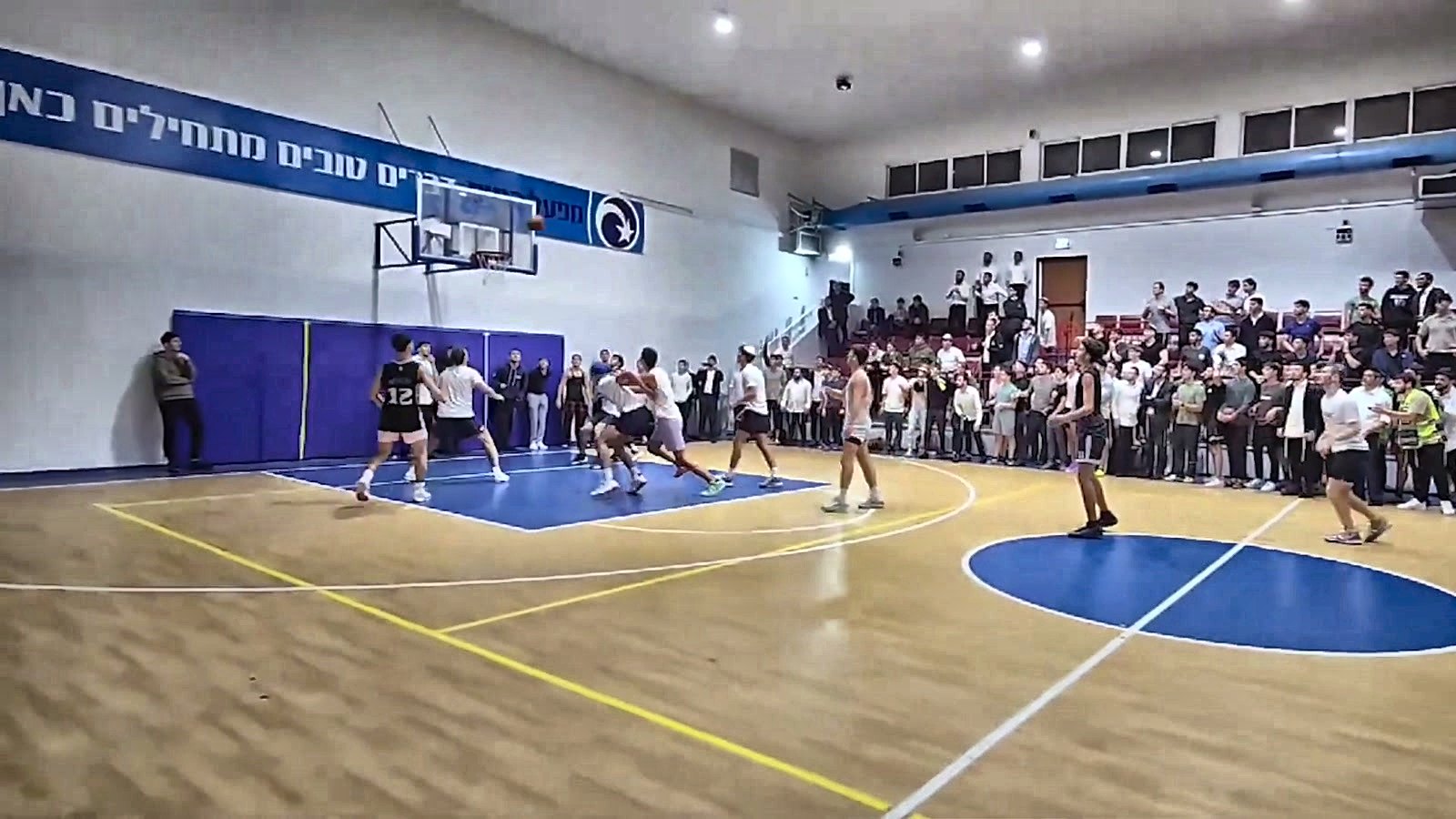 A basketball game in a packed gym