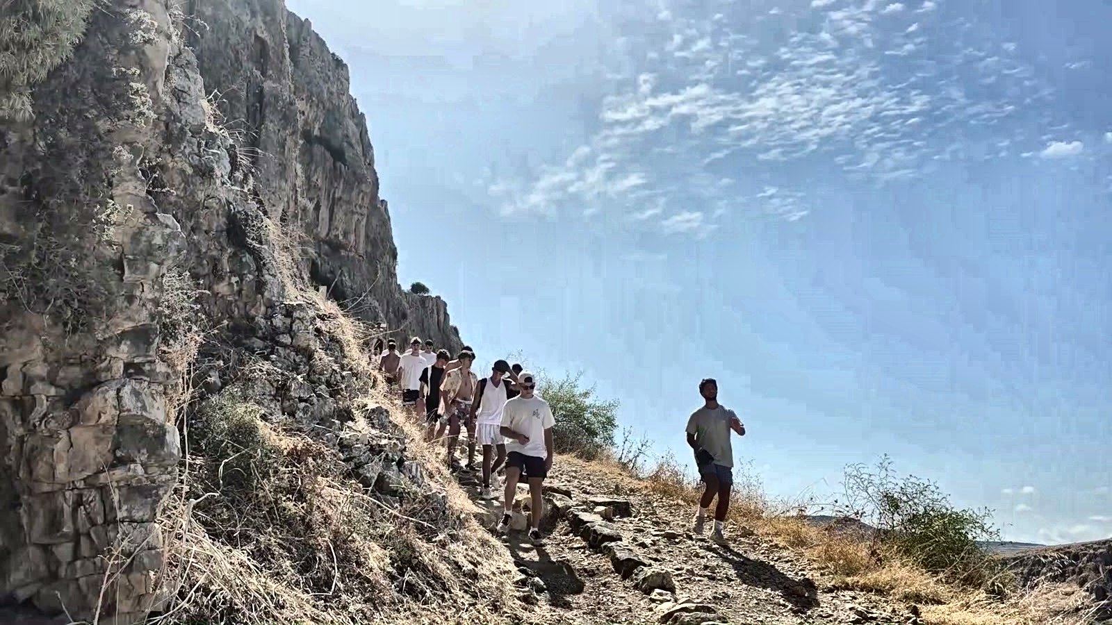 Talmidim climbing a cliff path on a hike