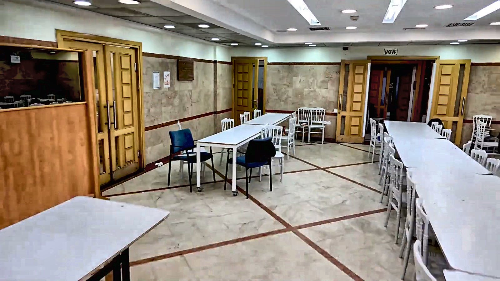 The yeshiva dining hall set with tables