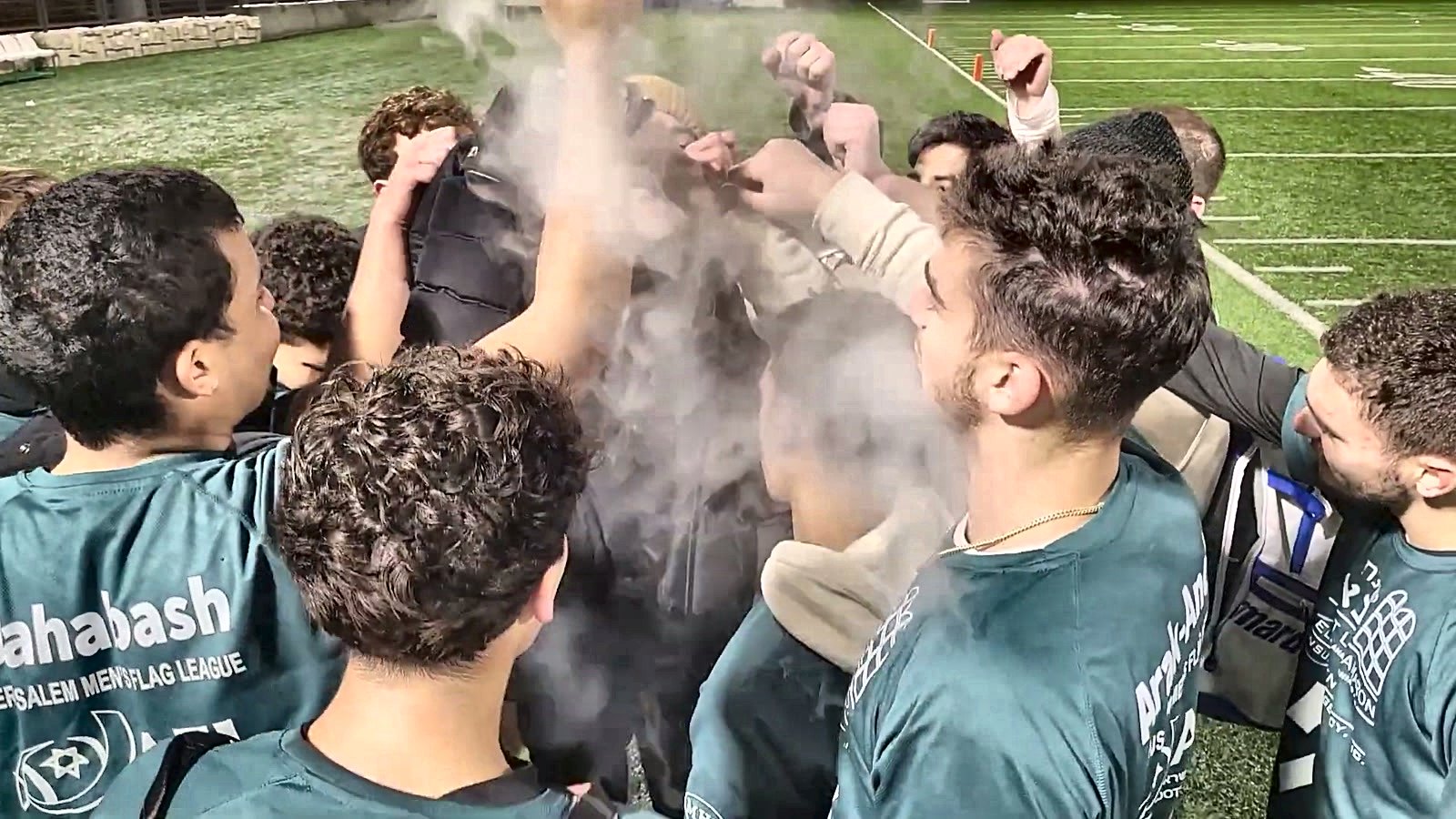 Talmidim celebrating in a huddle after a game