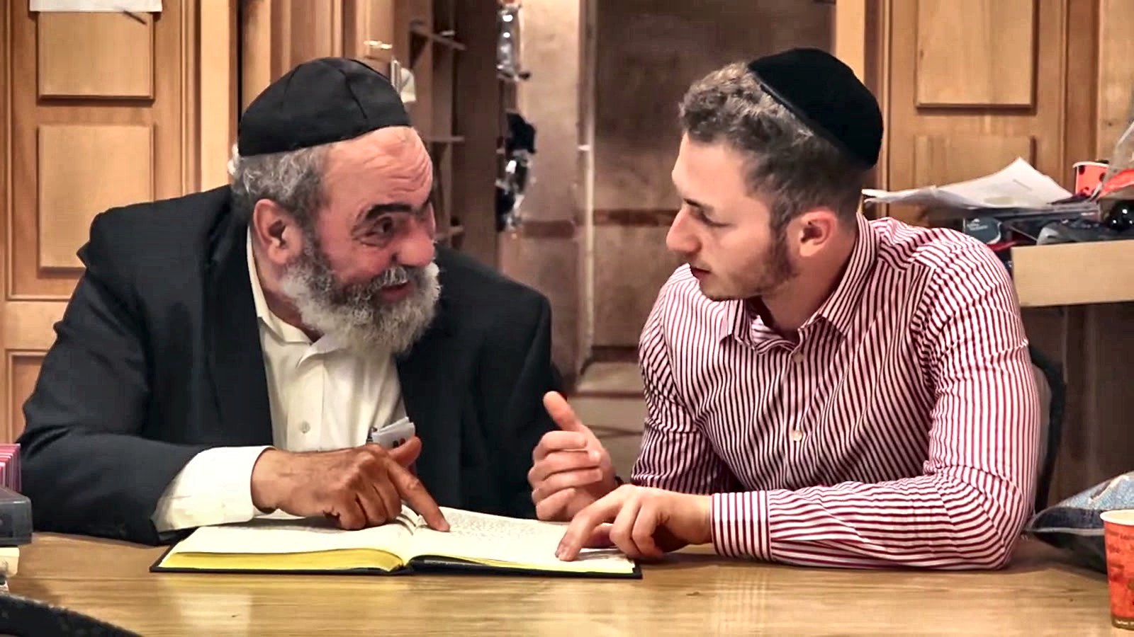 A rav learning one on one with a talmid over an open sefer