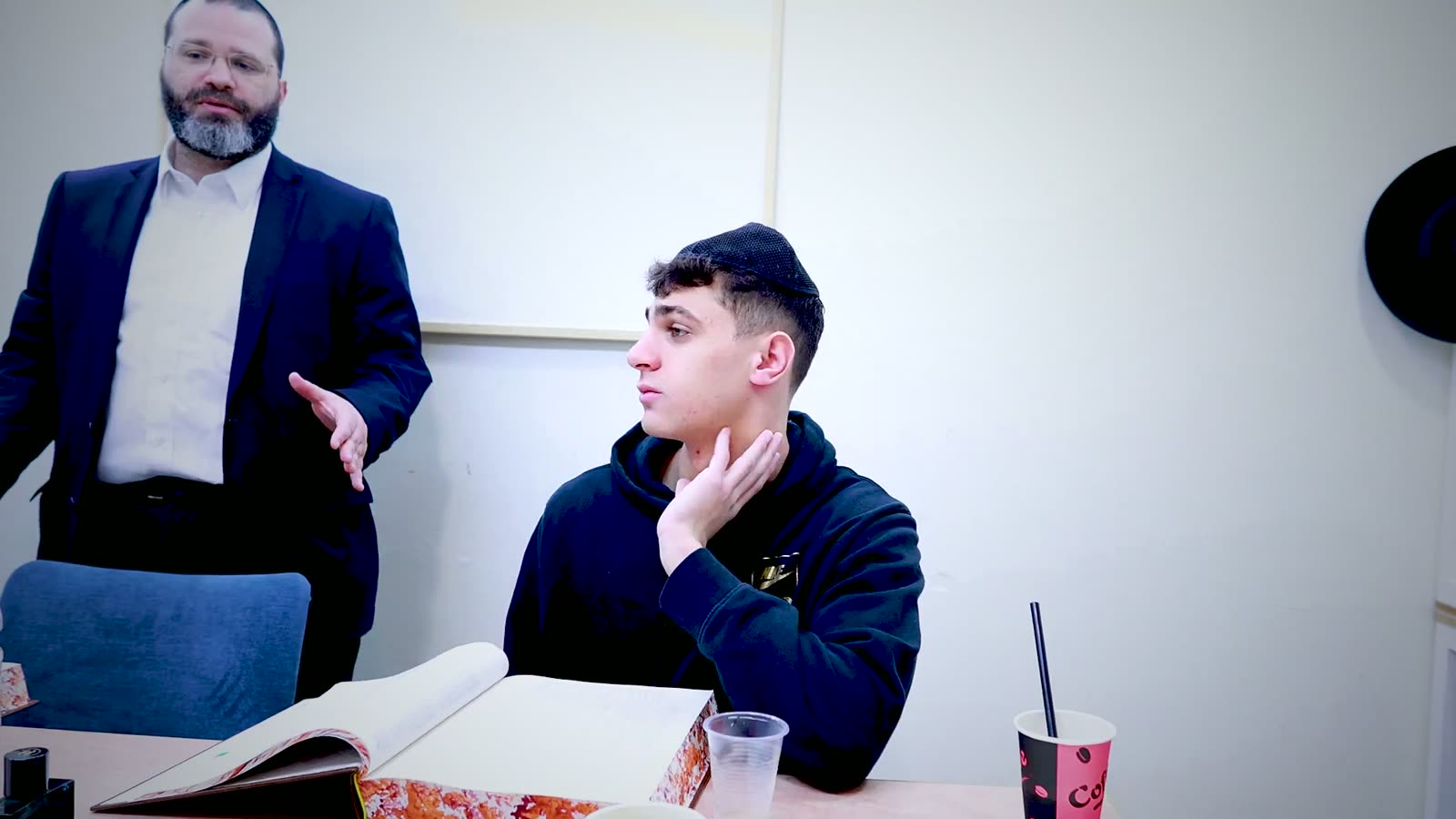 A rebbi explaining a sugya to a talmid one on one