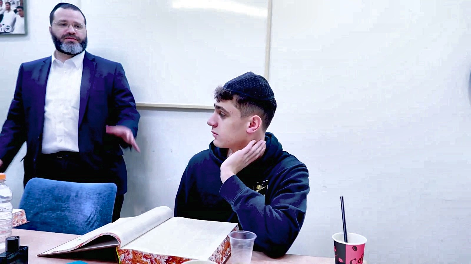 A rebbi teaching a talmid at his desk