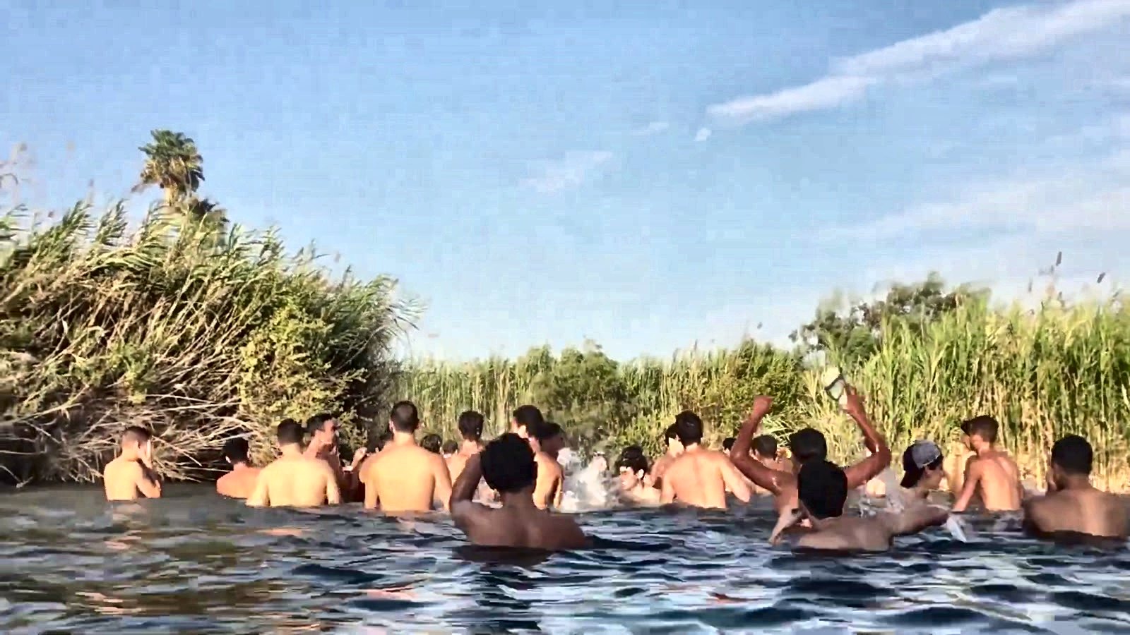 Talmidim swimming together in a river on a trip