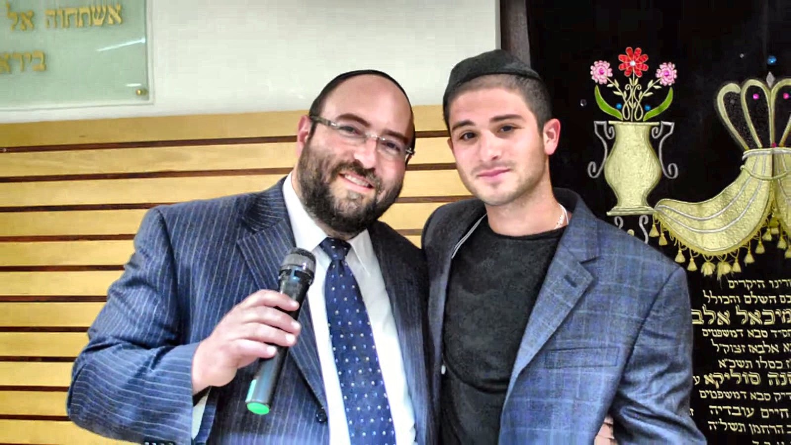 A rabbi speaking with a talmid at a yeshiva simcha