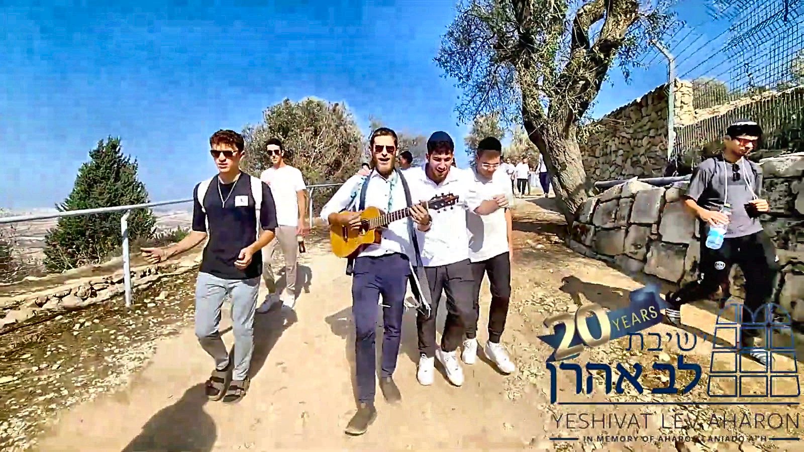 Talmidim walking together with a guitar on a yeshiva trip
